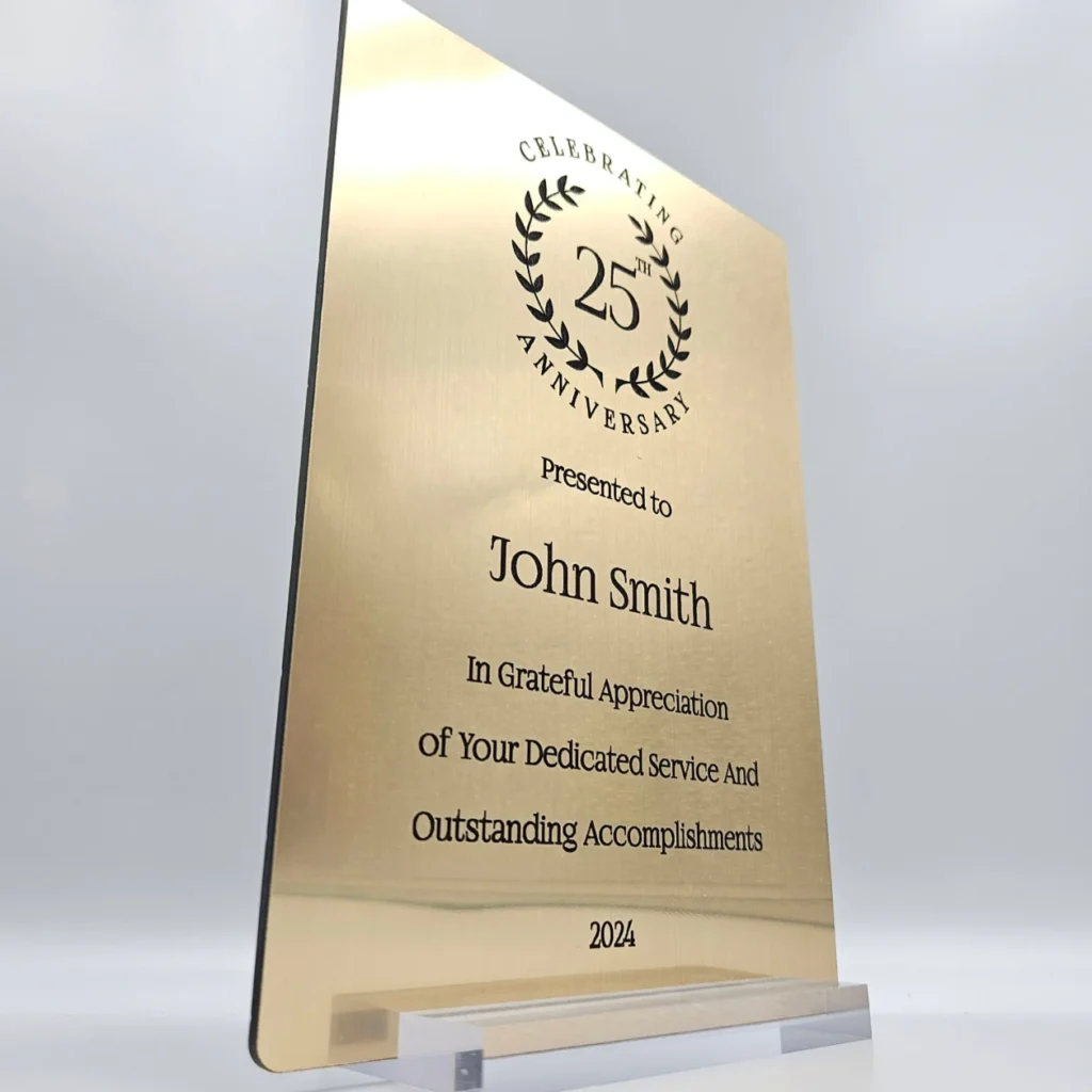 Personalized Anniversary Keepsake Gold Plaque with custom laser engraving in black, displayed in a transparent base.