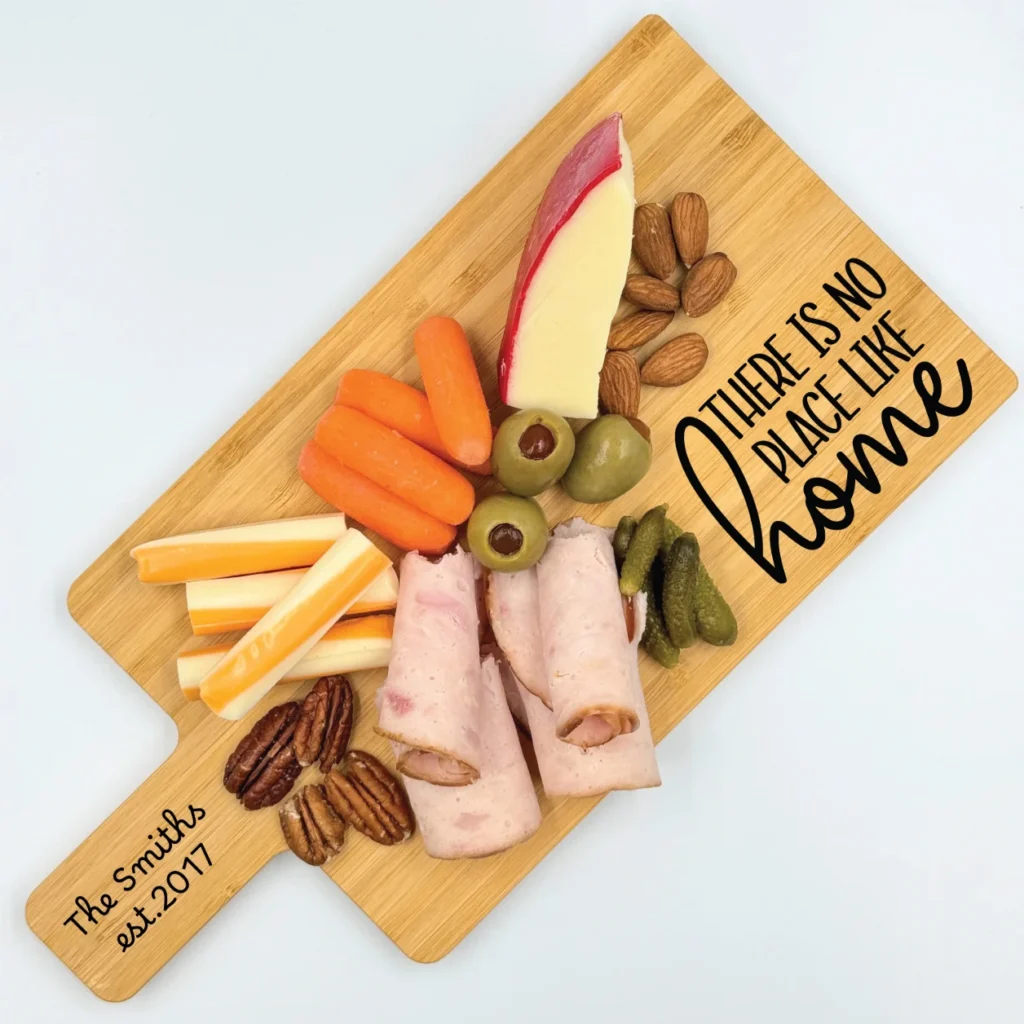Personalized bamboo charcuterie board with engraved text and design, perfect for serving and gifting.