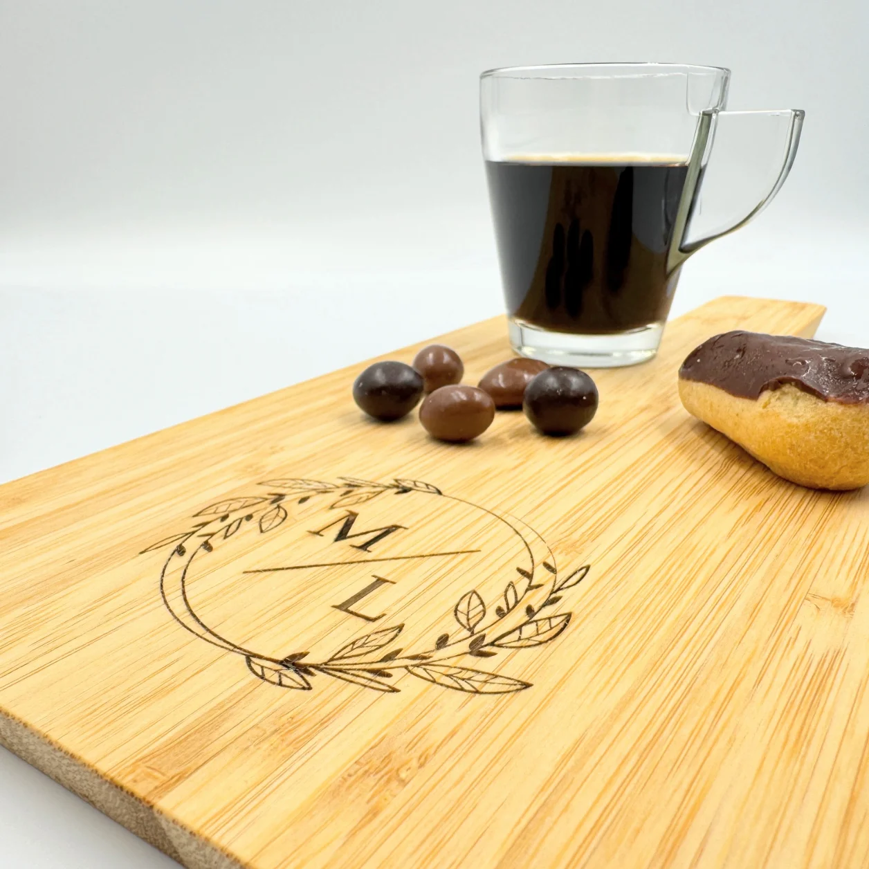 Personalized bamboo charcuterie board with engraved text and design, perfect for serving and gifting.