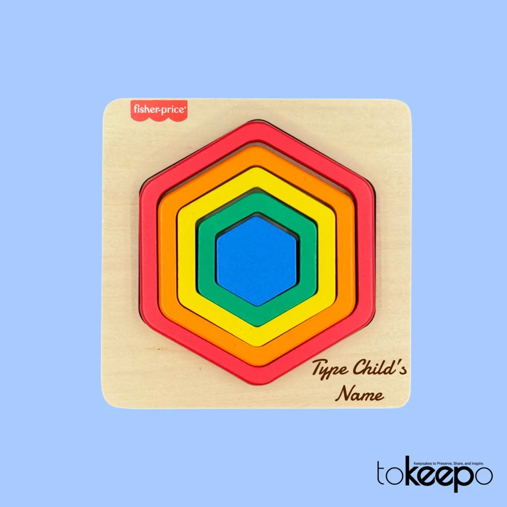 Fisher-Price® wooden hexagon puzzle for toddlers with colorful nesting layers, customizable with a name through tokeepo's personalization service.