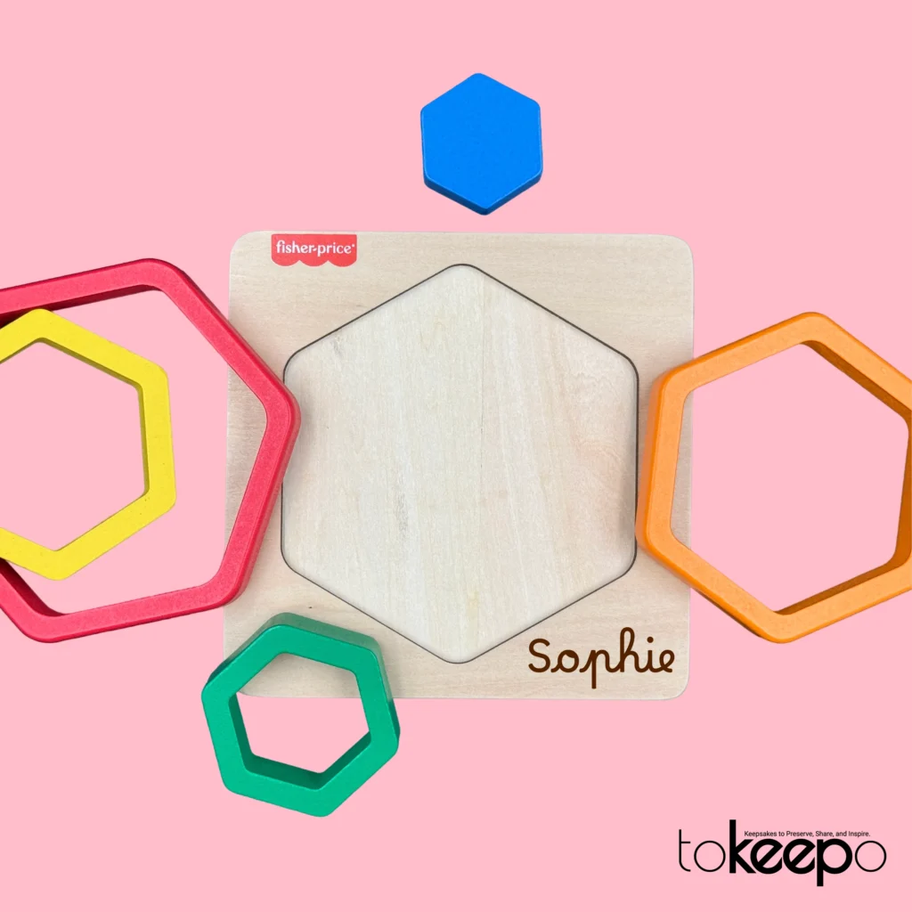 Fisher-Price® wooden hexagon puzzle for toddlers with colorful nesting layers, customizable with a name through tokeepo's personalization service.