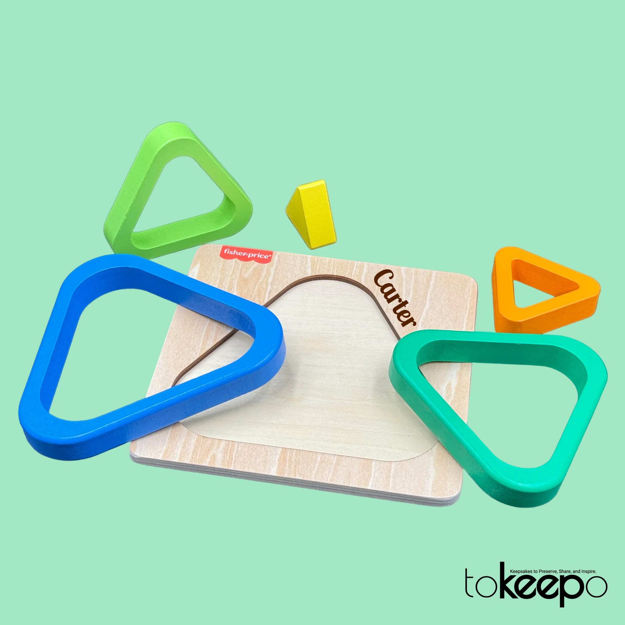 Fisher-Price® wooden triangle puzzle for toddlers with colorful nesting layers, customizable with a name through tokeepo's personalization service.