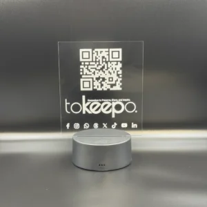 LED Acrylic Desk Lamp by tokeepo with a glowing acrylic plaque featuring engraved designs, including a QR code and logo, illuminated on a laser engraved transparent acrylic.