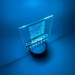 LED Acrylic Desk Lamp by tokeepo with a glowing acrylic plaque featuring engraved designs, including a QR code and logo, illuminated on a laser engraved transparent acrylic.