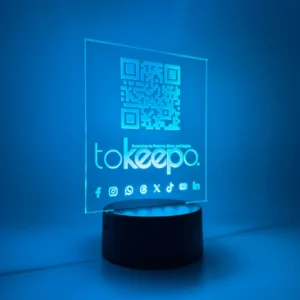 LED Acrylic Desk Lamp by tokeepo with a glowing acrylic plaque featuring engraved designs, including a QR code and logo, illuminated on a laser engraved transparent acrylic.