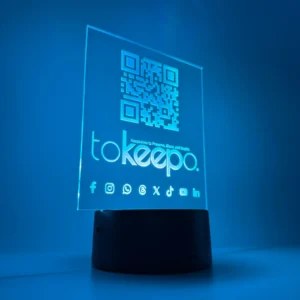 LED Acrylic Desk Lamp by tokeepo with a glowing acrylic plaque featuring engraved designs, including a QR code and logo, illuminated on a laser engraved transparent acrylic.