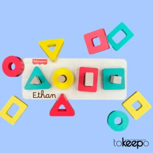 Personalized wooden stacking toy for toddlers, featuring colorful geometric shapes and an option to engrave a custom name on the base:"Ethan"