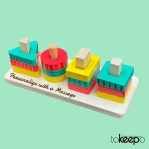 Personalized wooden stacking toy for toddlers, featuring colorful geometric shapes and an option to engrave a custom message on the base.