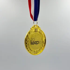 A gold medal with neck ribbon featuring a laurel wreath design, laser marked with the "tokeepo" logo in the center, hanging from a red, white, and blue ribbon.