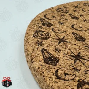 Personalized Ramadan cork trivet with laser engraved lantern and crescent pattern and Arabic calligraphy on a round cork surface.