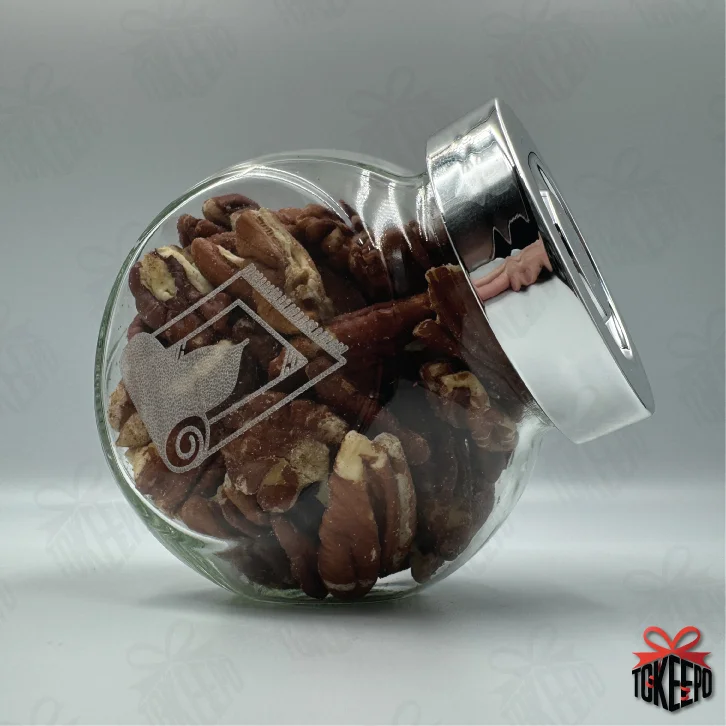 Engraved glass reward jar labeled for Salah, filled with pecans and shown on its side with a silver lid.