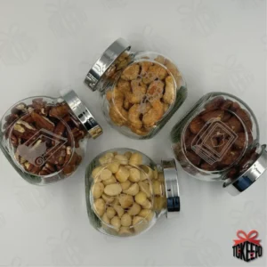 Set of four engraved glass reward jars with silver lids, filled with snacks and arranged in a flat lay.