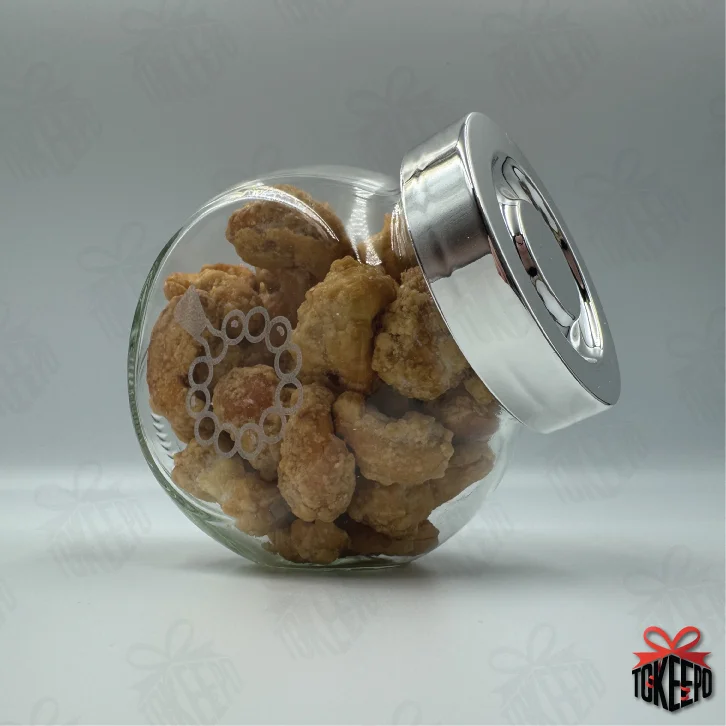 Engraved glass reward jar labeled for Tasbeeh, filled with snack bites and shown on its side with a silver lid.